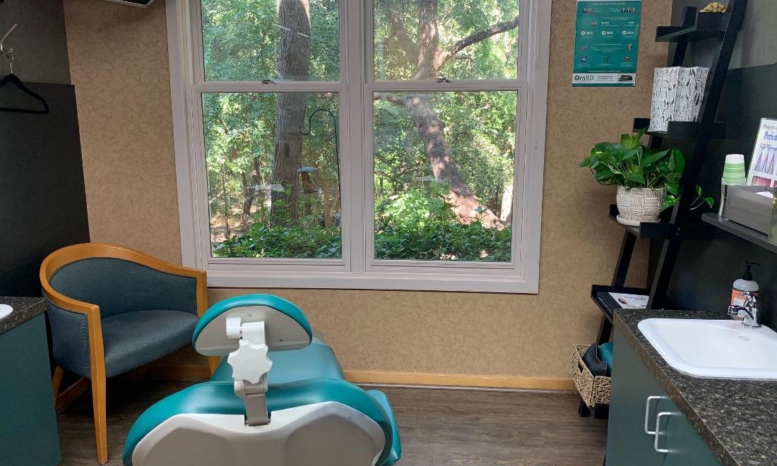 A comfortable treatment room with views of bird feeders and the greenbelt